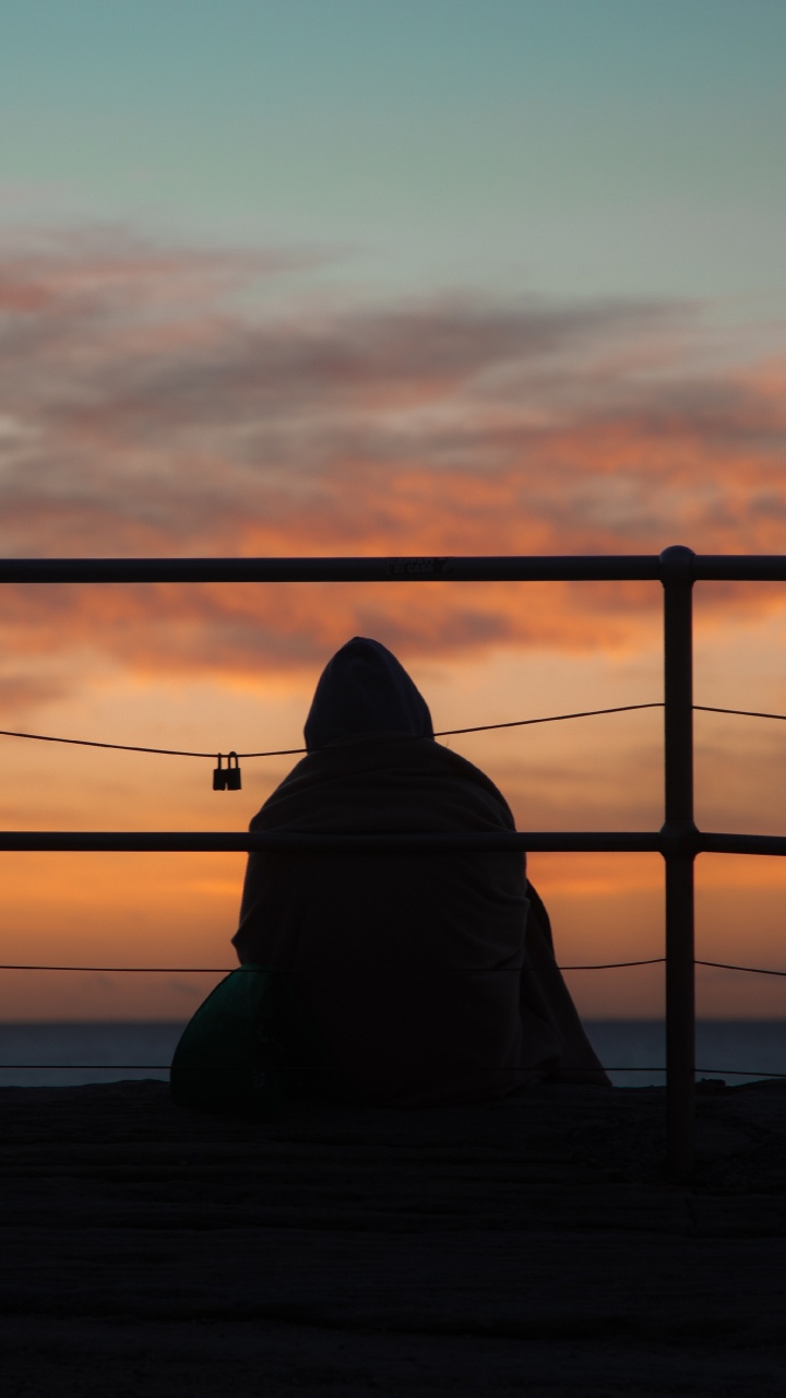 Silhouette of Person Sitting on Wooden Dock During Sunset. Wallpaper in 720x1280 Resolution