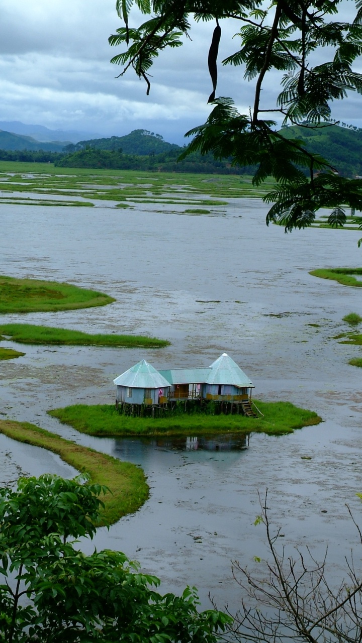 White and Brown Gazebo on Green Grass Field Near Body of Water During Daytime. Wallpaper in 720x1280 Resolution