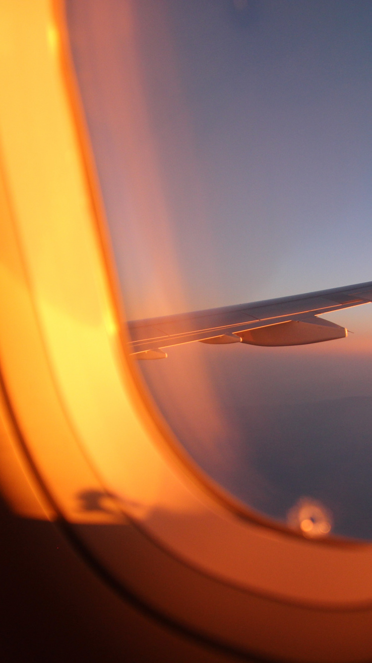 Airplane Window View of Orange and White Sky During Daytime. Wallpaper in 750x1334 Resolution