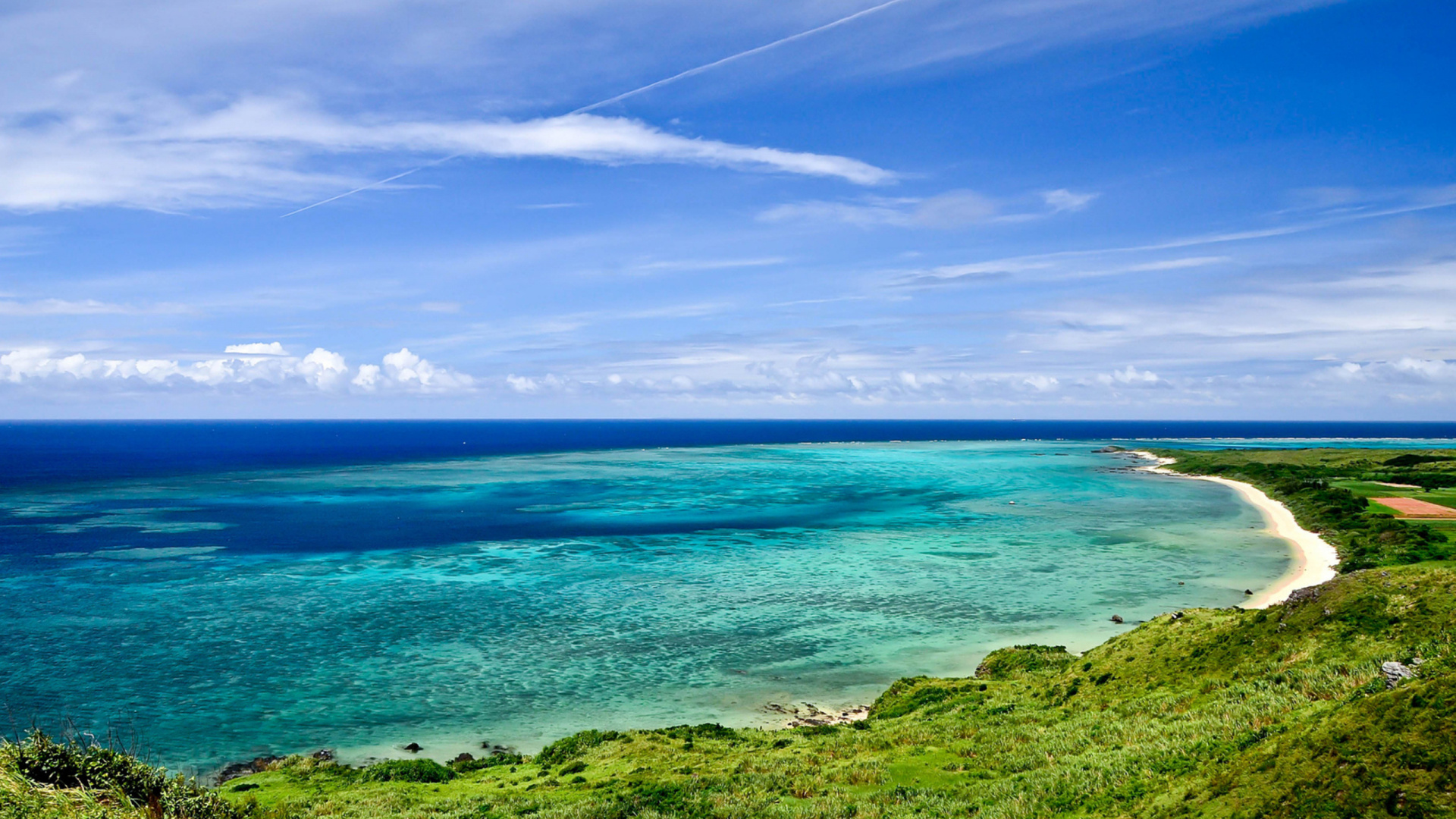 Green Grass Field Near Body of Water Under Blue Sky During Daytime. Wallpaper in 1920x1080 Resolution