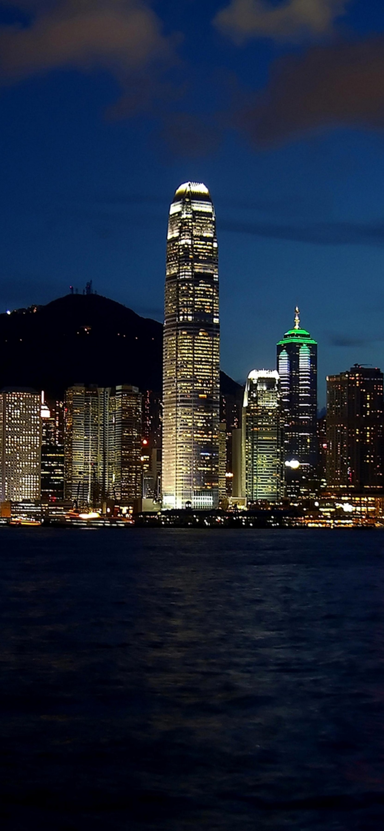City Skyline Across Body of Water During Night Time. Wallpaper in 1242x2688 Resolution
