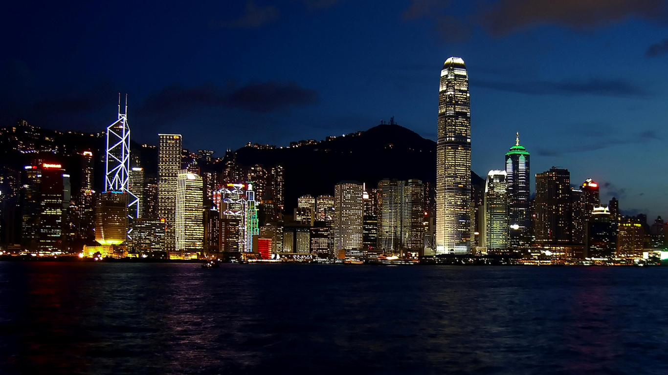 City Skyline Across Body of Water During Night Time. Wallpaper in 1366x768 Resolution