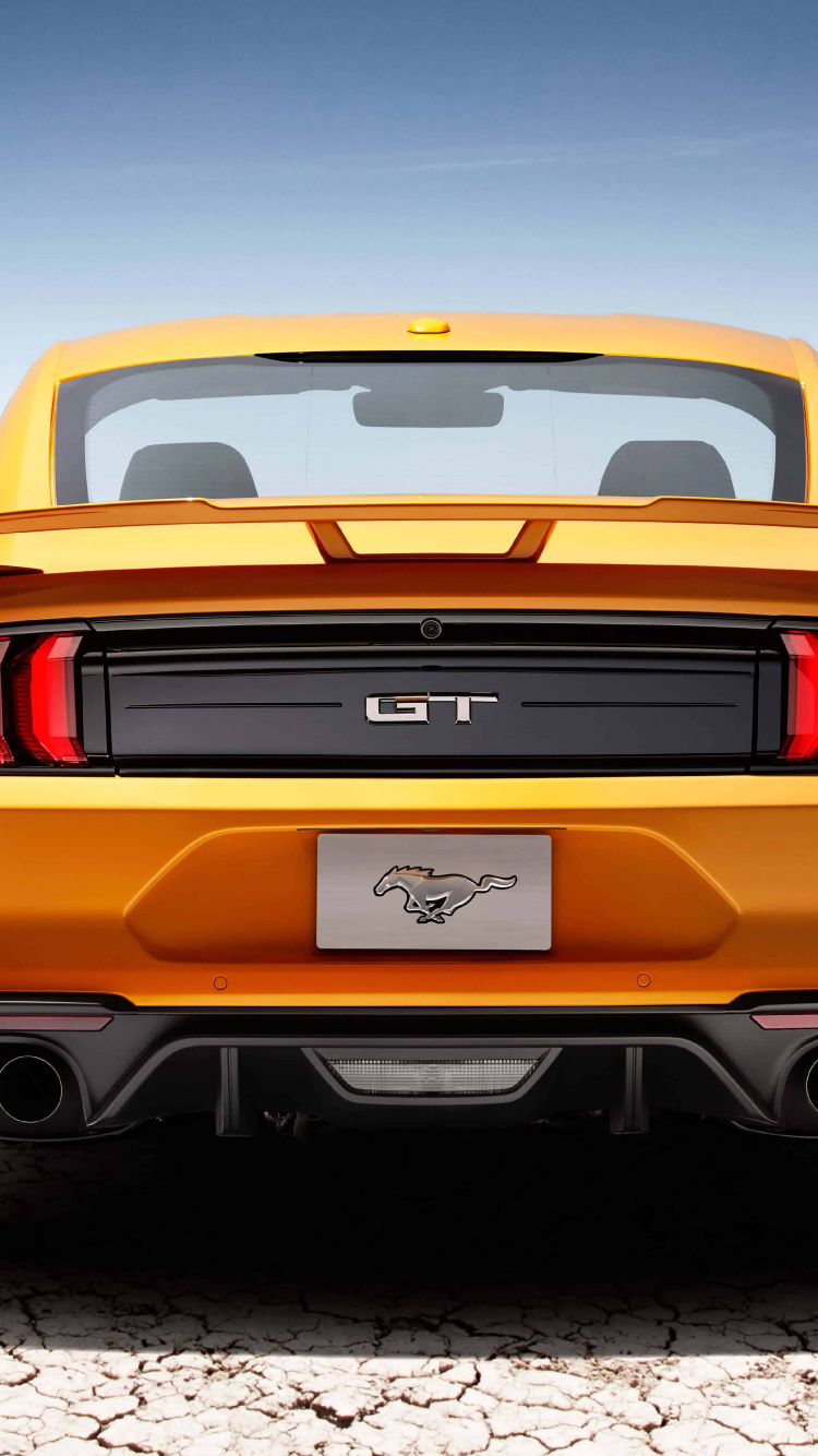 Orange Chevrolet Camaro on Road During Daytime. Wallpaper in 750x1334 Resolution