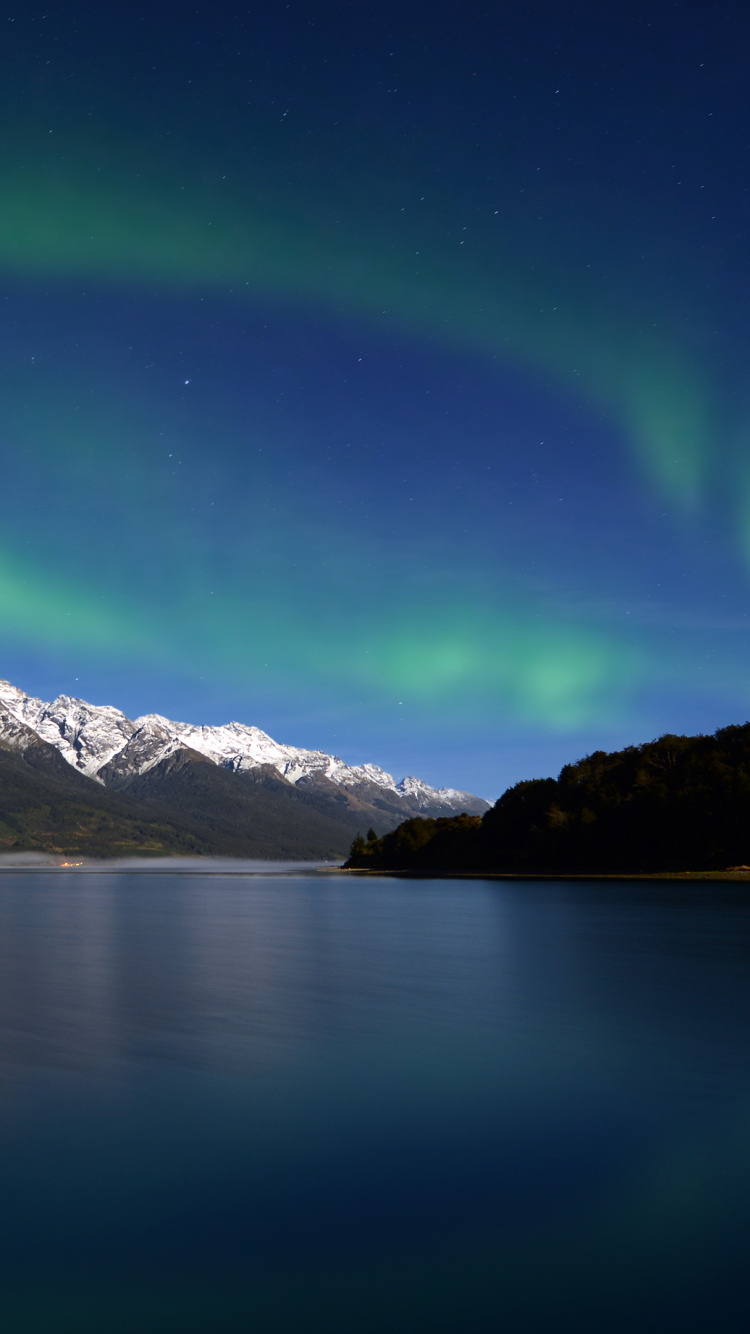 Snow Covered Mountain Beside Body of Water During Daytime. Wallpaper in 750x1334 Resolution