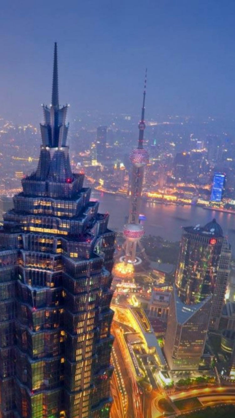 Aerial View of City Buildings During Night Time. Wallpaper in 750x1334 Resolution