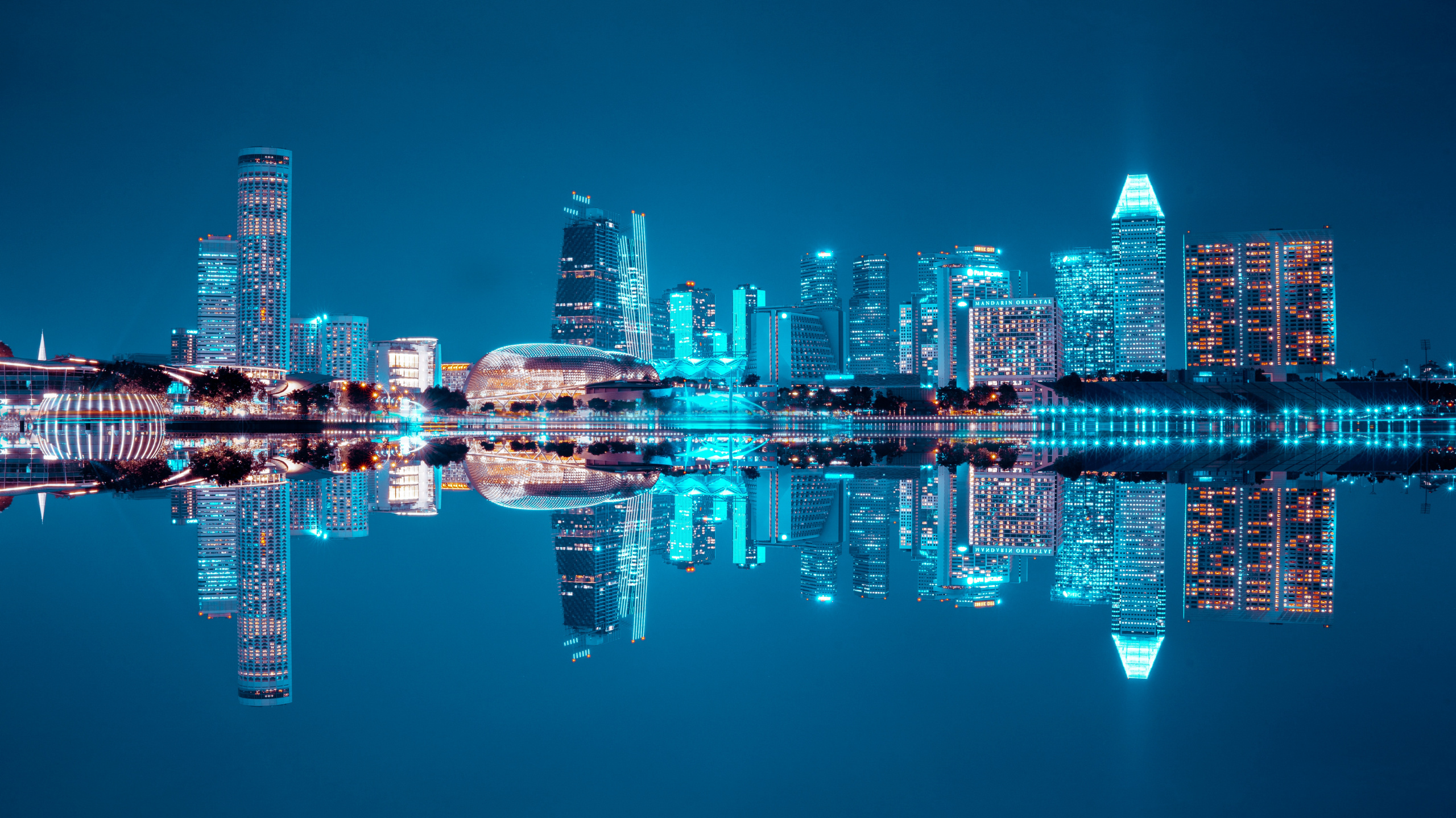 City Skyline Across Body of Water During Night Time. Wallpaper in 2560x1440 Resolution