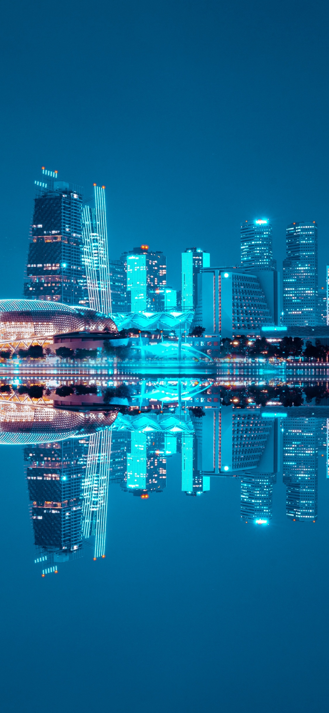 Horizon de la Ville à Travers le Plan D'eau Pendant la Nuit. Wallpaper in 1125x2436 Resolution