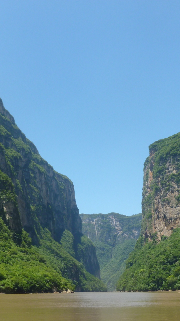 Green Mountain Beside River During Daytime. Wallpaper in 720x1280 Resolution