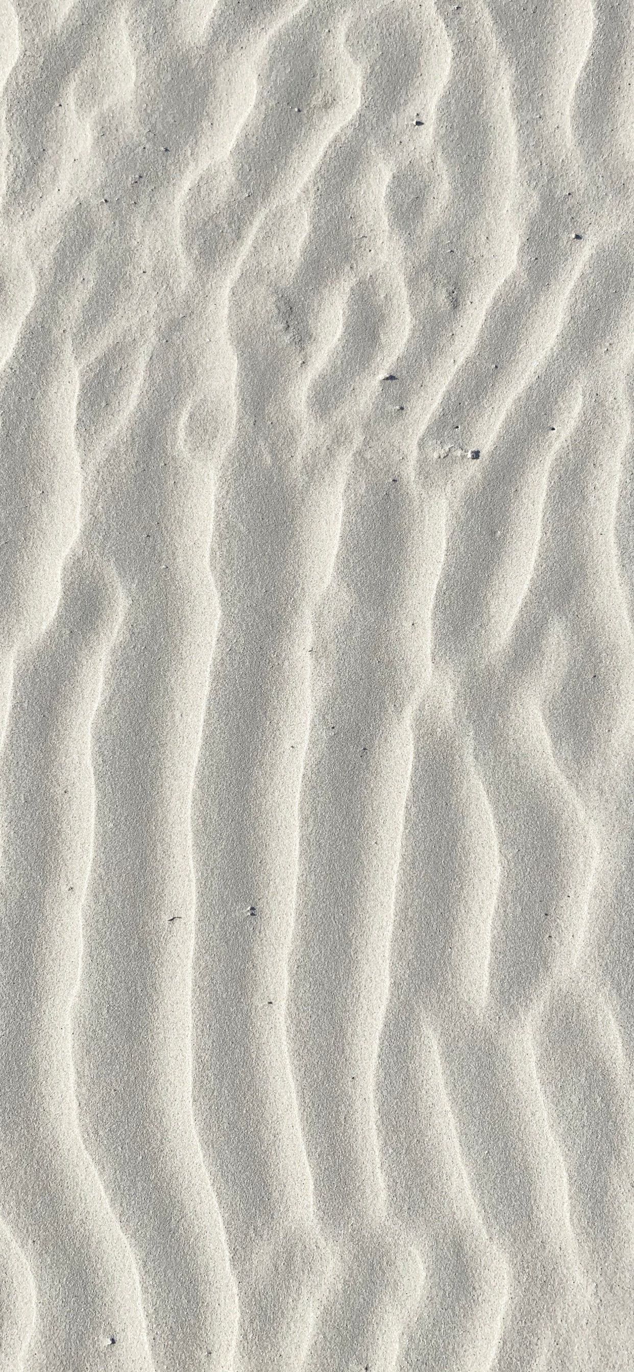 Brown Sand With Footprints During Daytime. Wallpaper in 1242x2688 Resolution