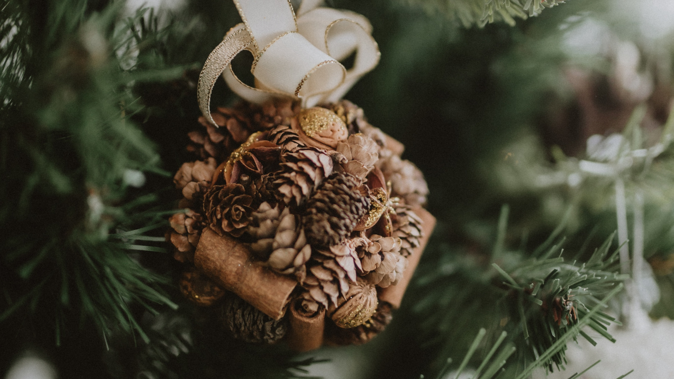 Brown Pine Cone on Green Christmas Tree. Wallpaper in 1366x768 Resolution