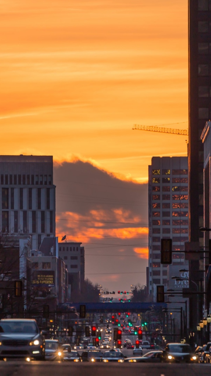 Cars on Road Between High Rise Buildings During Sunset. Wallpaper in 720x1280 Resolution