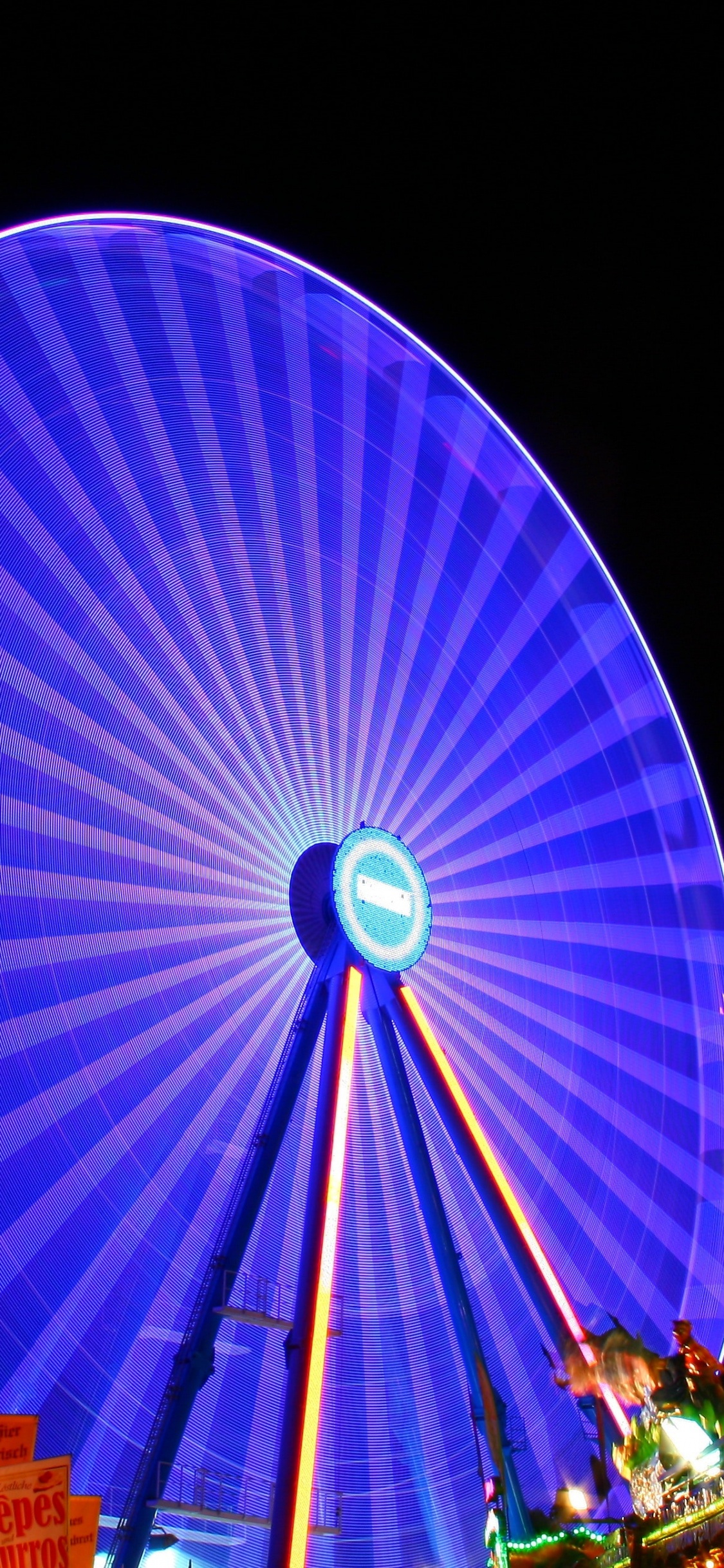 Grande Roue Bleue et Rouge Pendant la Nuit. Wallpaper in 1125x2436 Resolution