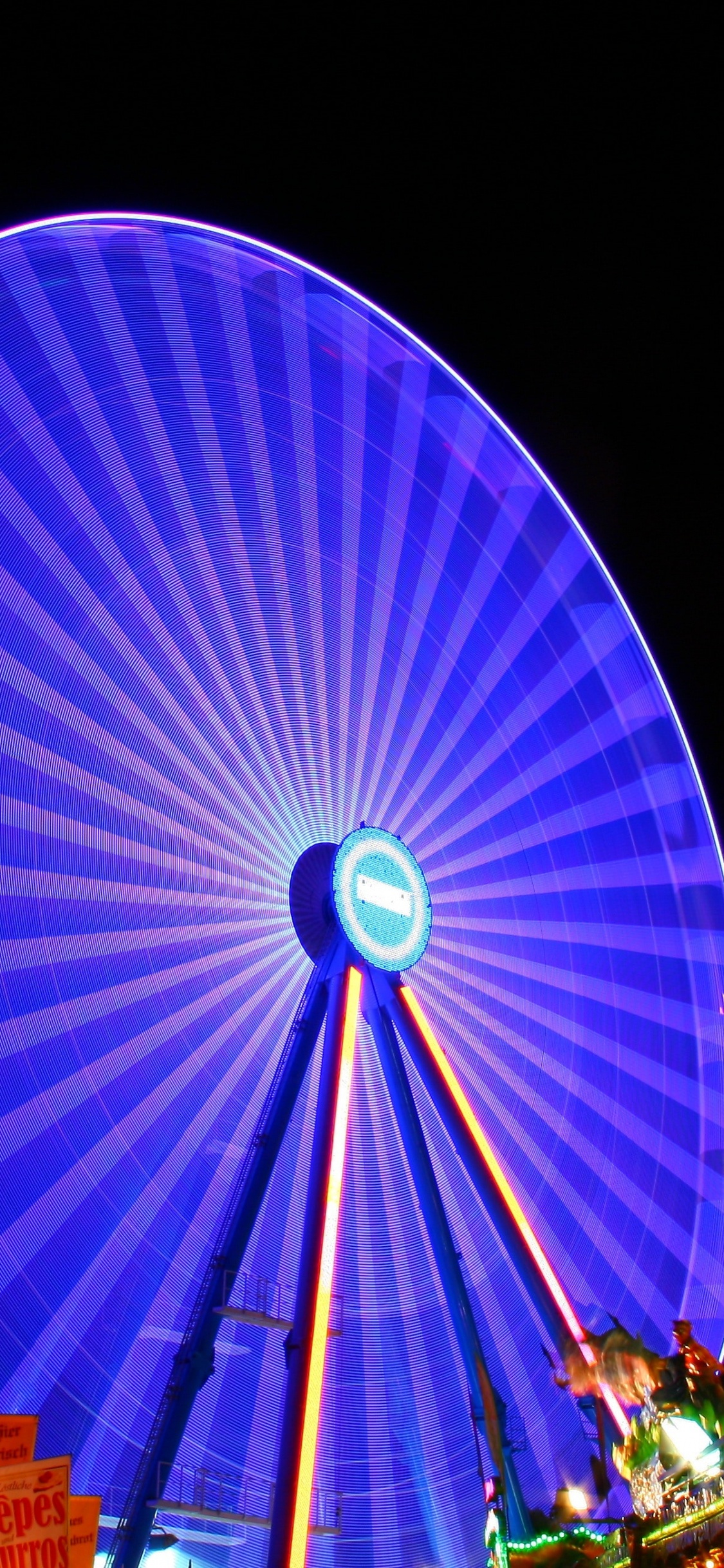 Blue and Red Ferris Wheel During Night Time. Wallpaper in 1125x2436 Resolution