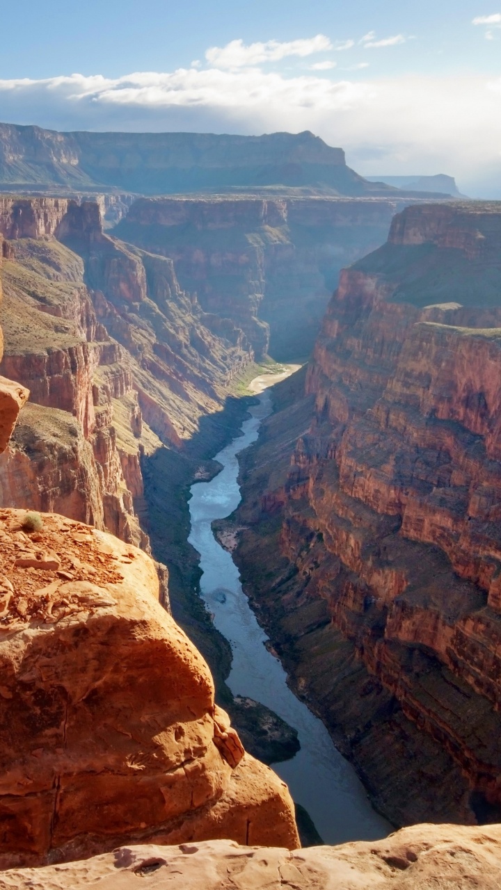Brown Rocky Mountain With River in The Middle. Wallpaper in 720x1280 Resolution
