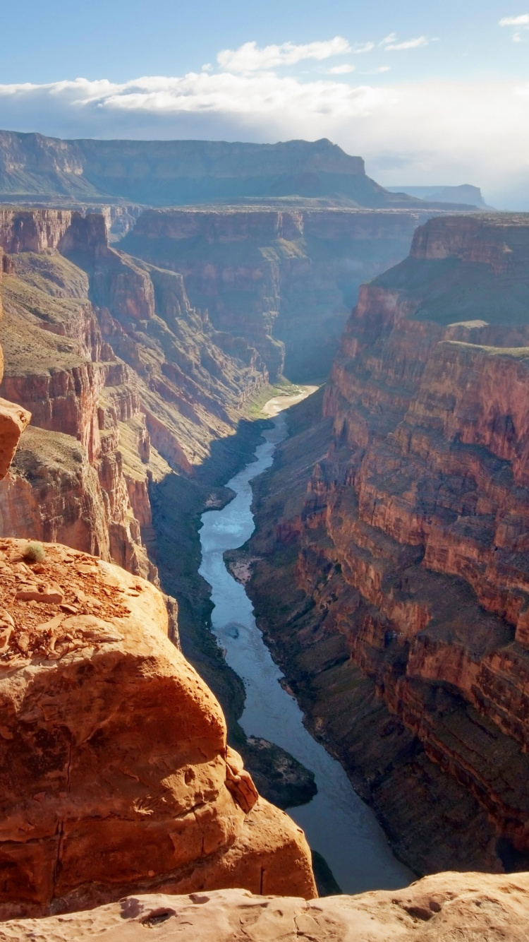 Brown Rocky Mountain With River in The Middle. Wallpaper in 750x1334 Resolution