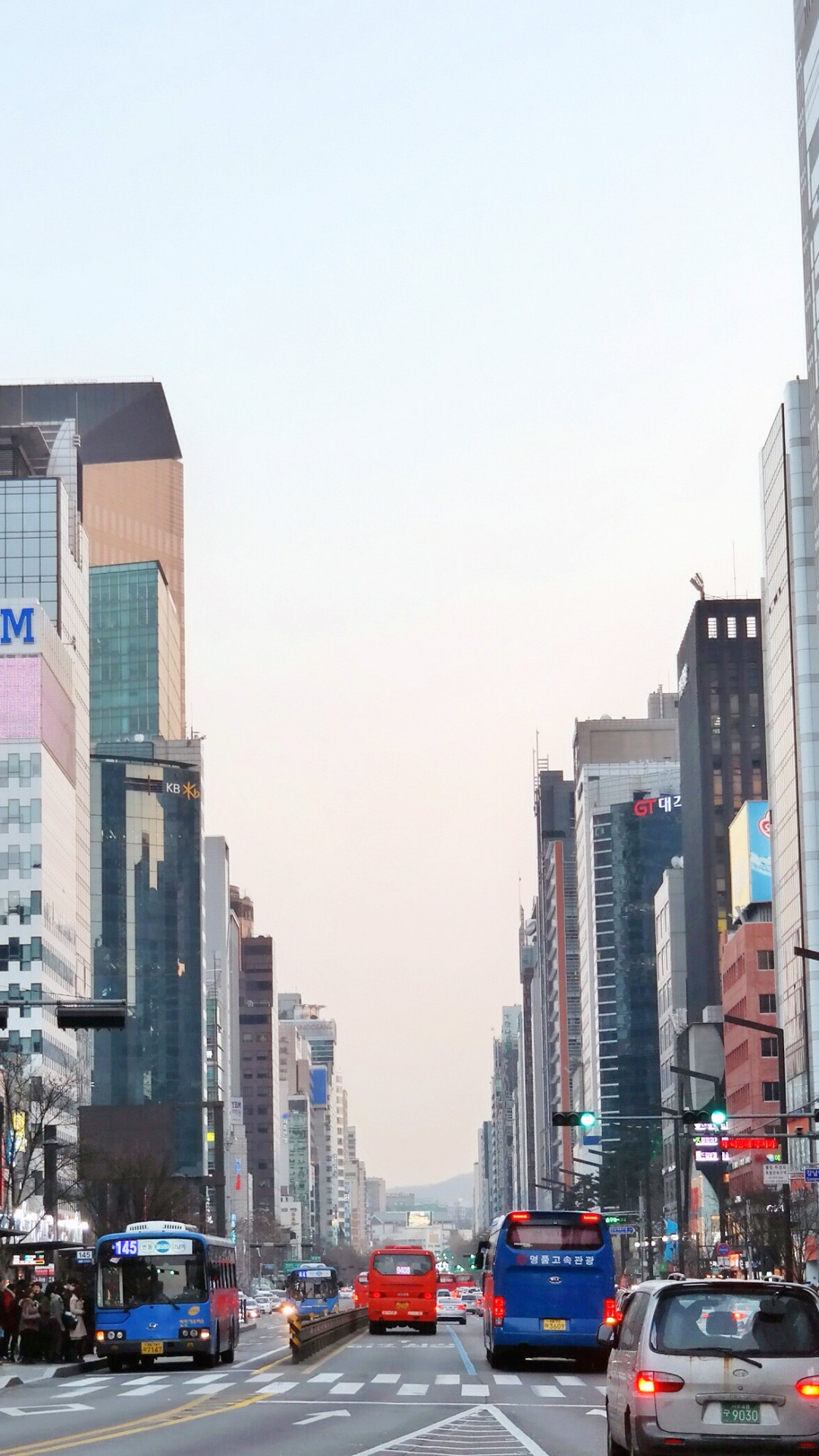 Cars on Road Between High Rise Buildings During Daytime. Wallpaper in 1080x1920 Resolution