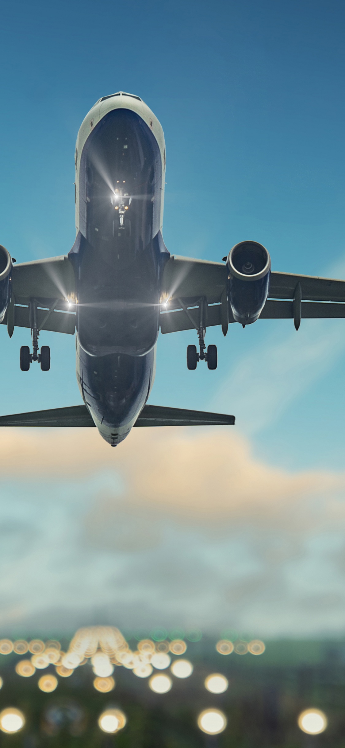 White and Blue Airplane Flying During Daytime. Wallpaper in 1125x2436 Resolution