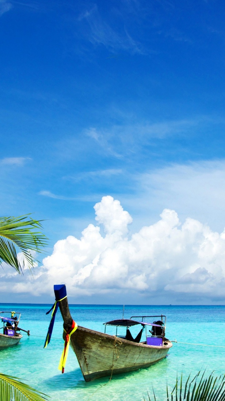Man in Blue Shirt Riding on Boat on Sea Under Blue and White Cloudy Sky During. Wallpaper in 720x1280 Resolution