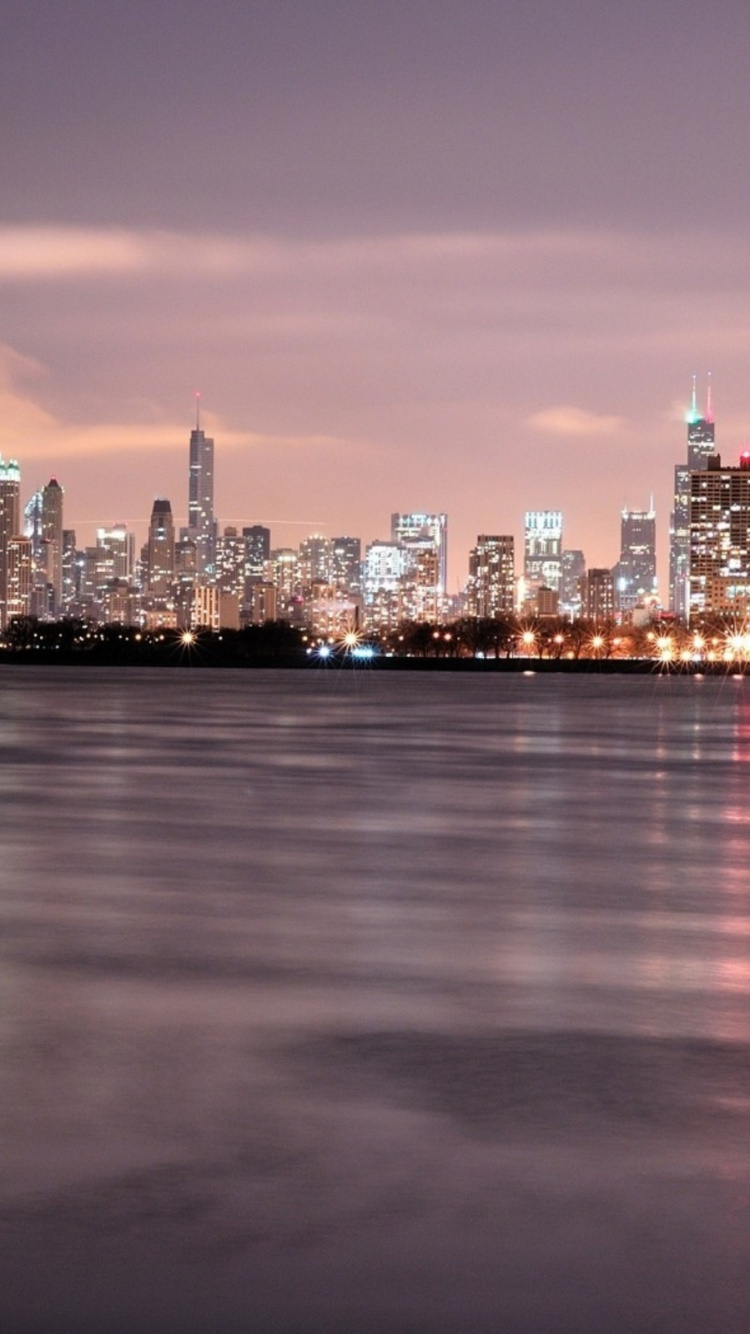 City Skyline Across Body of Water During Night Time. Wallpaper in 750x1334 Resolution