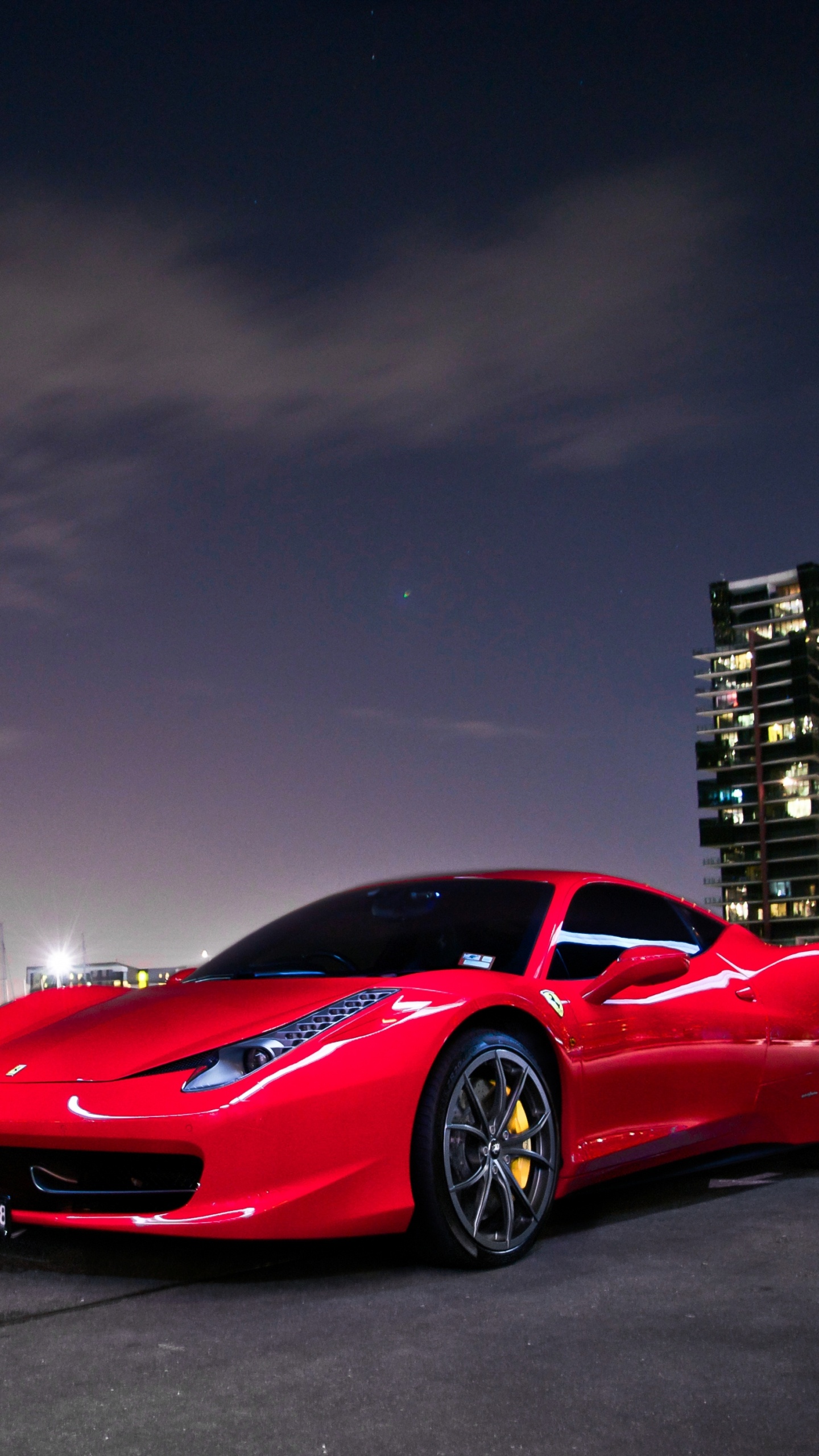 Roter Ferrari 458 Italia Unterwegs in Der Nähe Von Stadtgebäuden Während Der Nachtzeit. Wallpaper in 1440x2560 Resolution