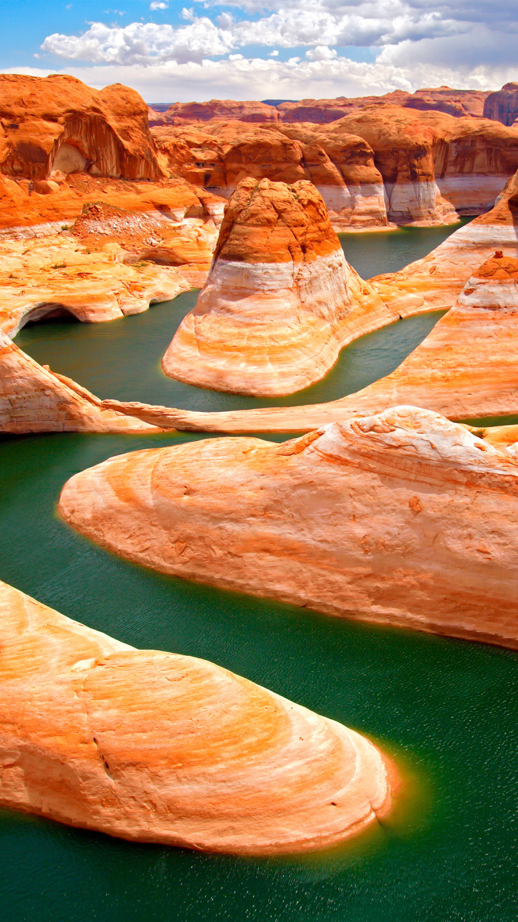 Brown Rock Formation Near Green Water. Wallpaper in 750x1334 Resolution