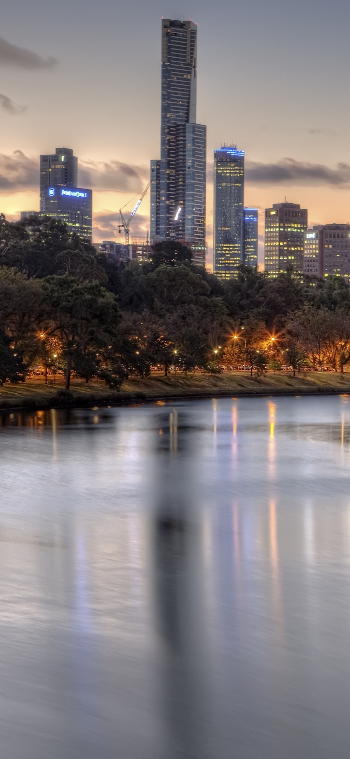 Body of Water Near Trees and Buildings During Daytime. Wallpaper in 1125x2436 Resolution