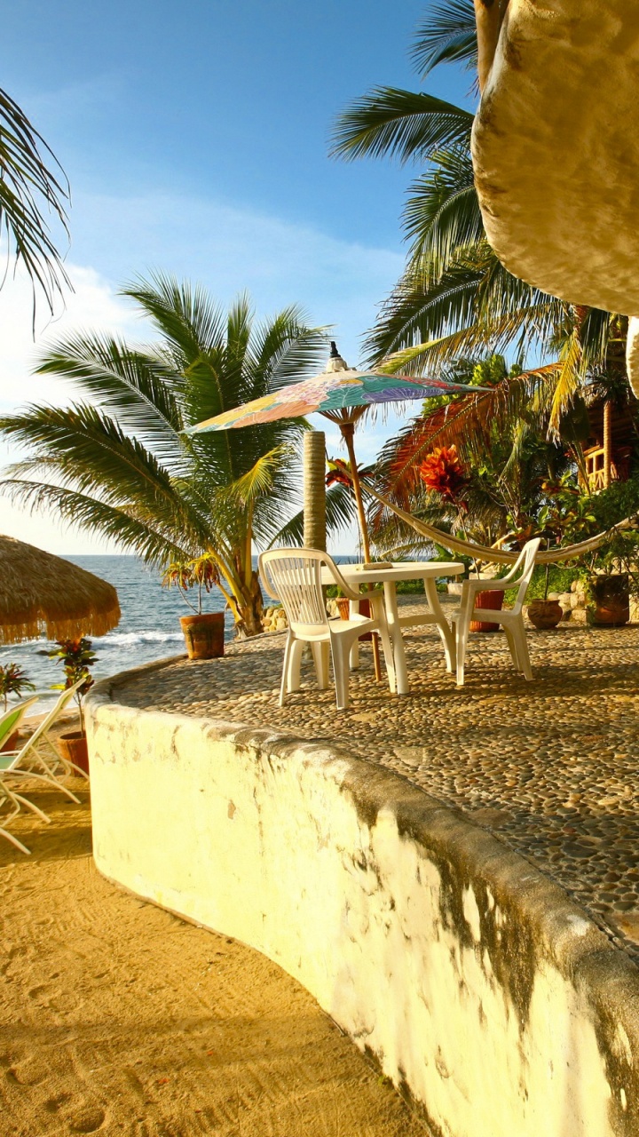 Brown Wooden Chairs and Table Near Palm Trees During Daytime. Wallpaper in 720x1280 Resolution