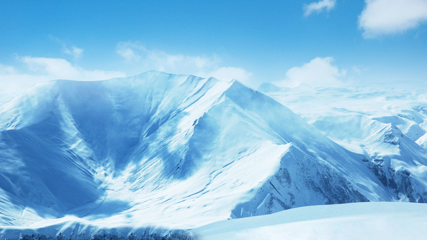 Snow Covered Mountain Under Blue Sky. Wallpaper in 1366x768 Resolution