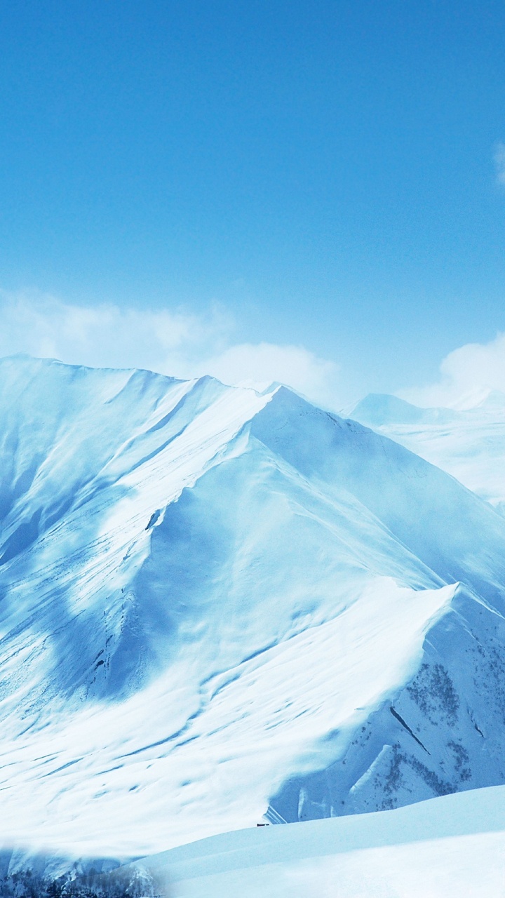 Snow Covered Mountain Under Blue Sky. Wallpaper in 720x1280 Resolution