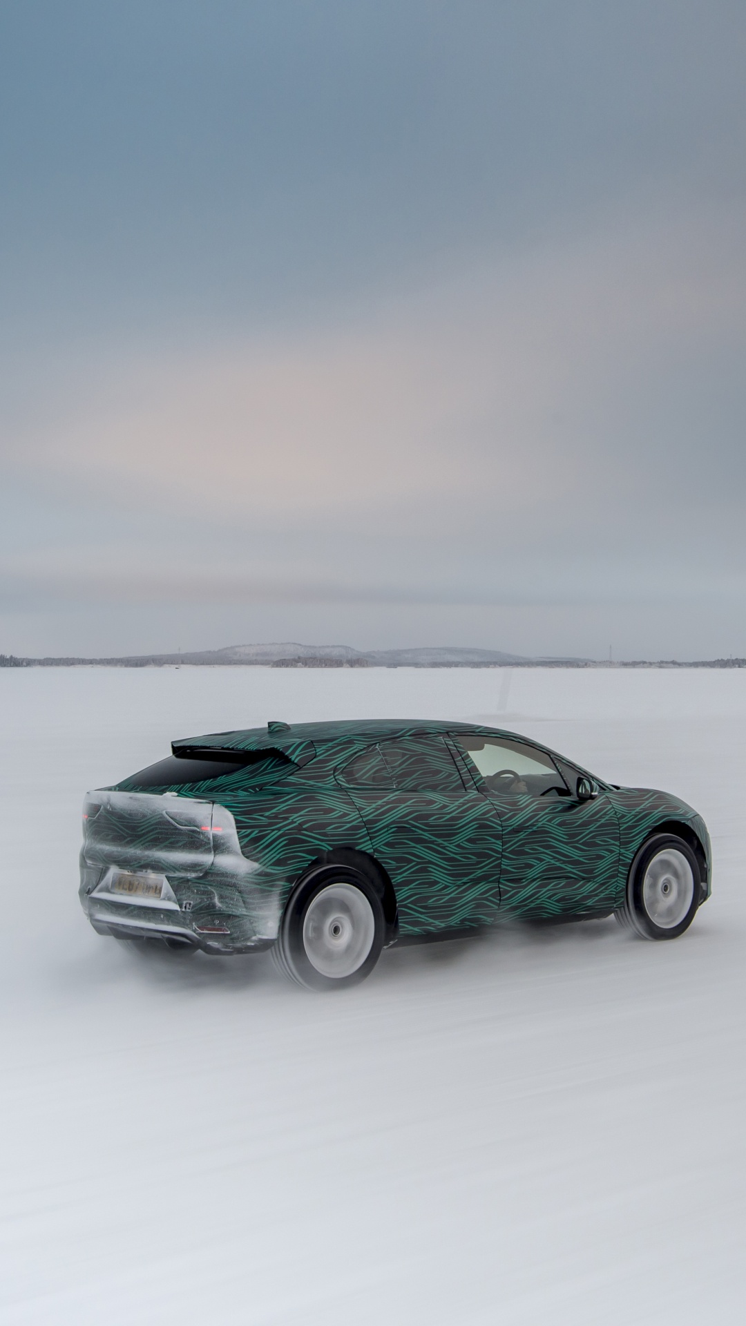 Green Car on Snow Covered Field. Wallpaper in 1080x1920 Resolution