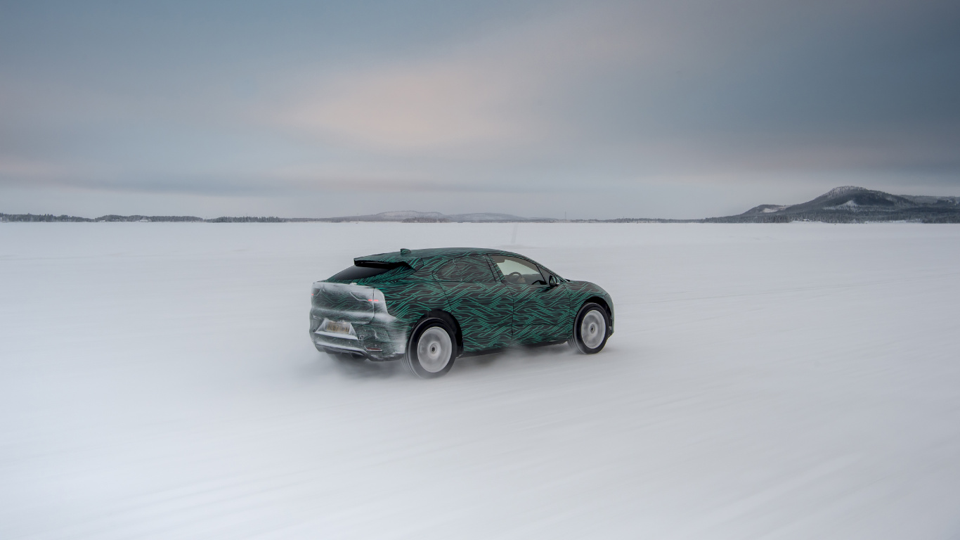 Green Car on Snow Covered Field. Wallpaper in 1366x768 Resolution