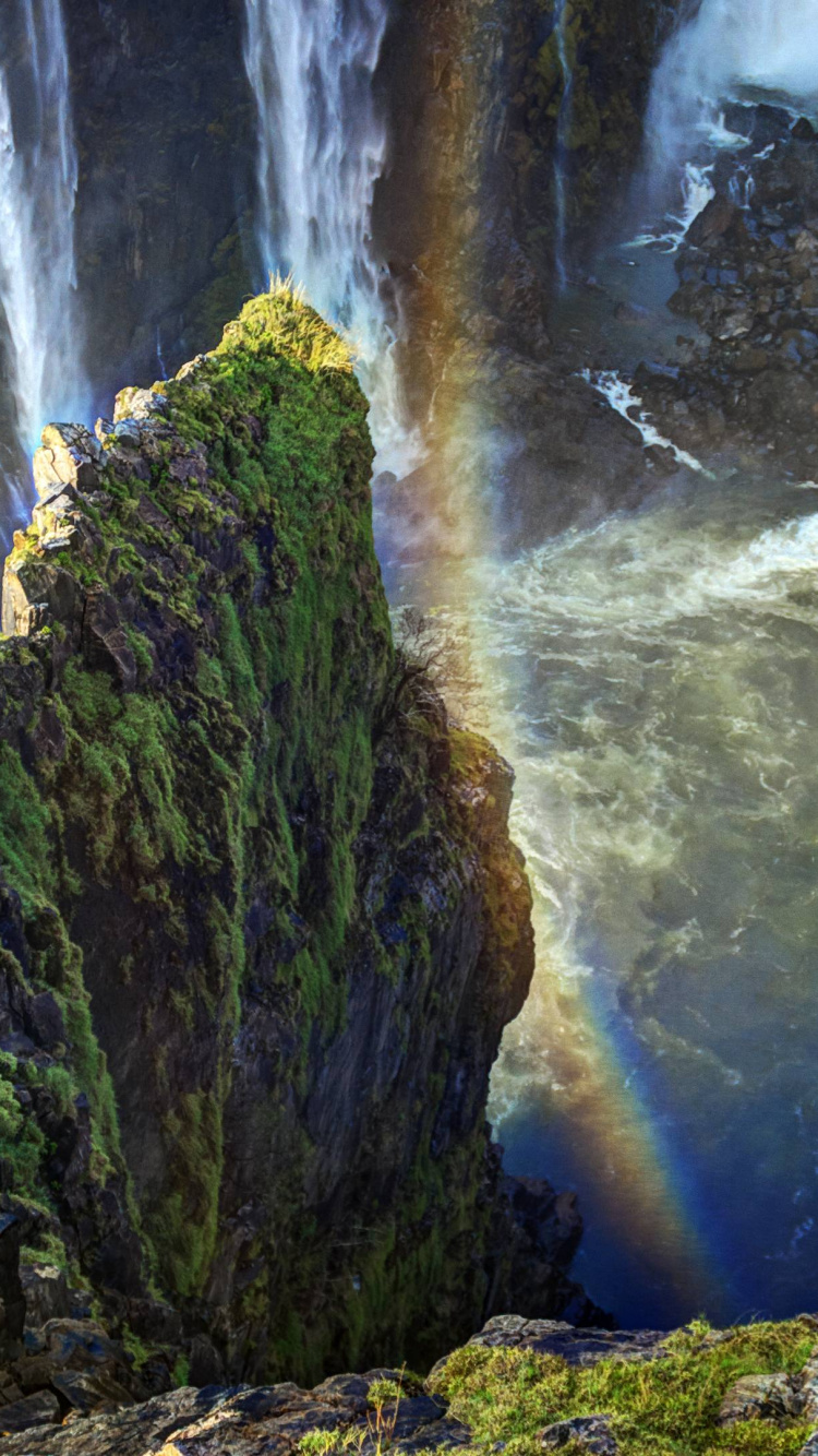 Green Moss on Brown Rock Formation Near Waterfalls During Daytime. Wallpaper in 750x1334 Resolution