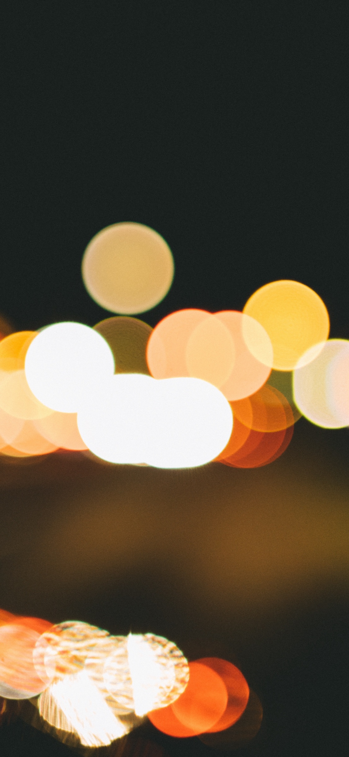 Bokeh Photography of Yellow Lights. Wallpaper in 1125x2436 Resolution