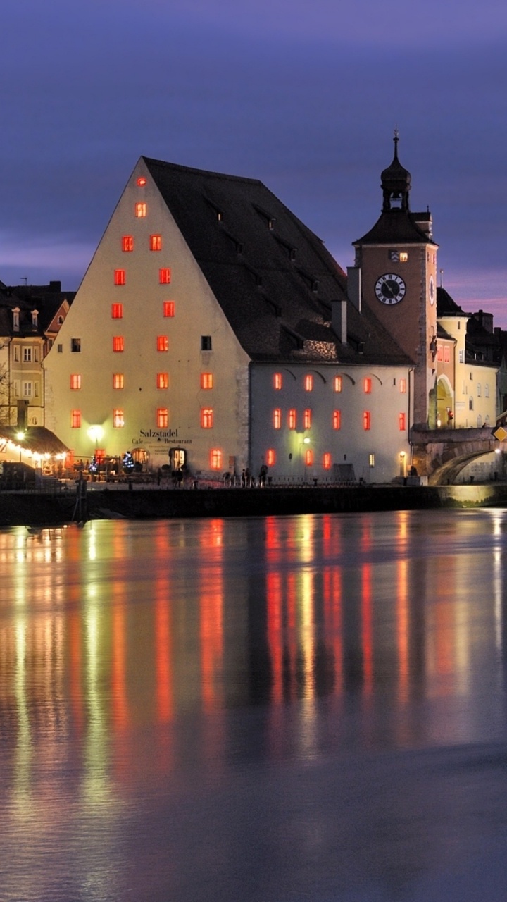 Brown and White Concrete Building Near Body of Water During Night Time. Wallpaper in 720x1280 Resolution