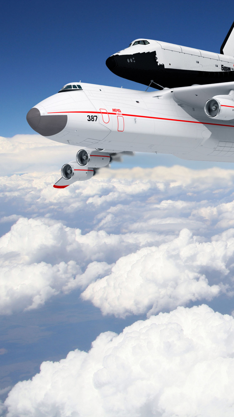 Avión Blanco y Rojo Bajo Nubes Blancas y Cielo Azul Durante el Día. Wallpaper in 750x1334 Resolution