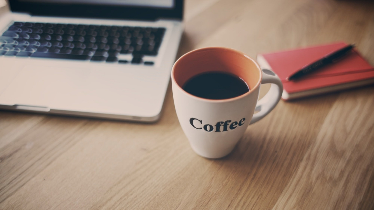 White Ceramic Mug Beside Macbook Pro. Wallpaper in 1280x720 Resolution