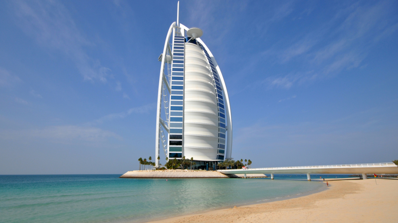 White and Blue Glass Building Near Sea During Daytime. Wallpaper in 1280x720 Resolution