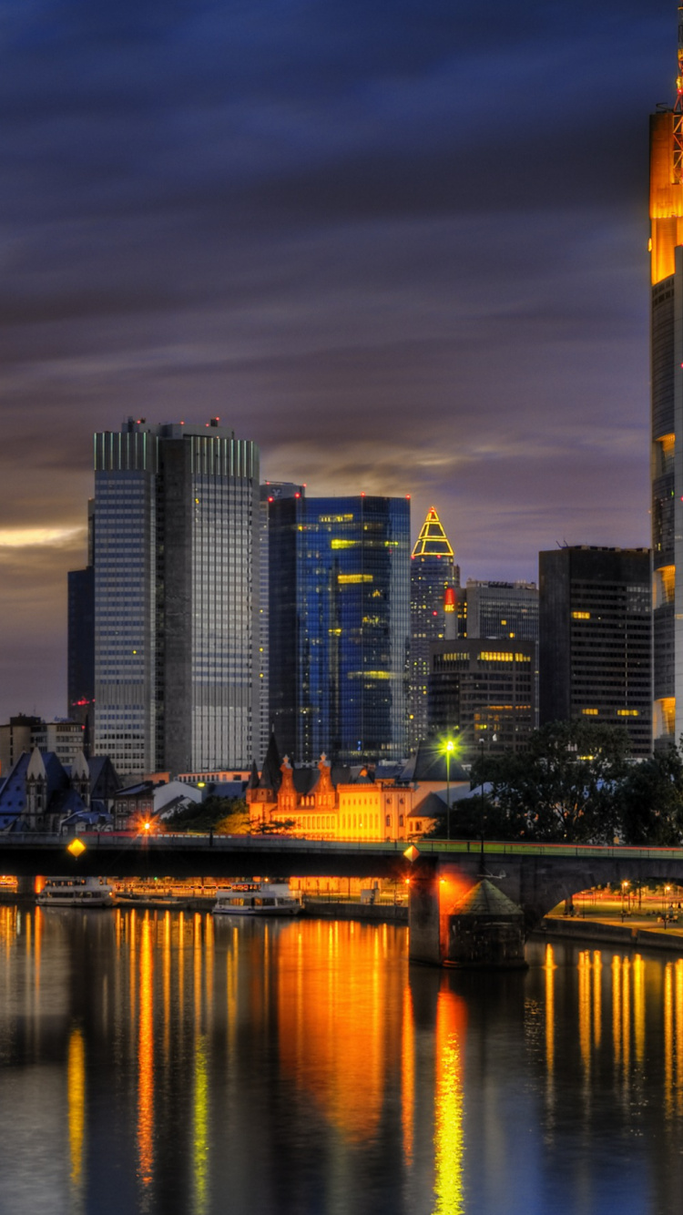 City Skyline Across Body of Water During Night Time. Wallpaper in 750x1334 Resolution