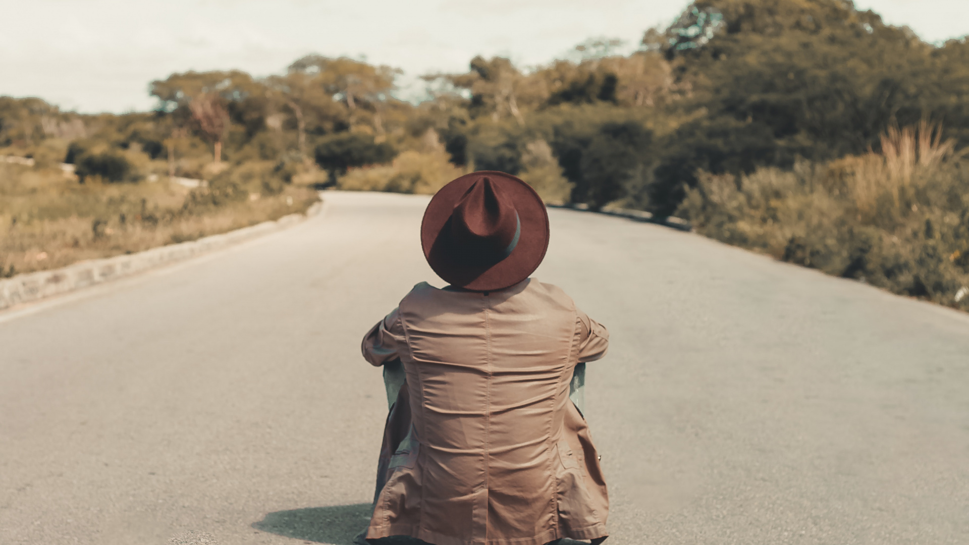 Woman in Brown Hijab Sitting on Gray Asphalt Road During Daytime. Wallpaper in 1920x1080 Resolution