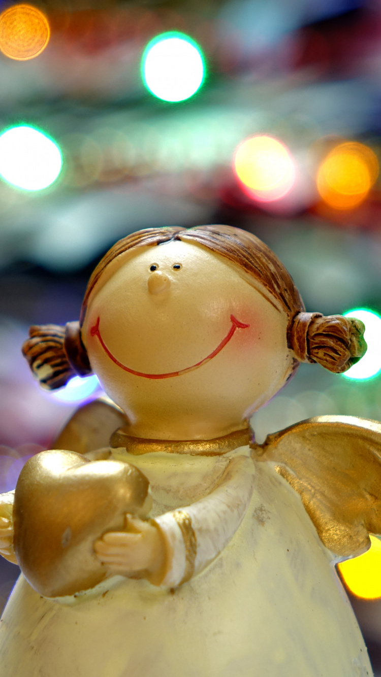 White Angel Ceramic Figurine in Bokeh Photography. Wallpaper in 750x1334 Resolution