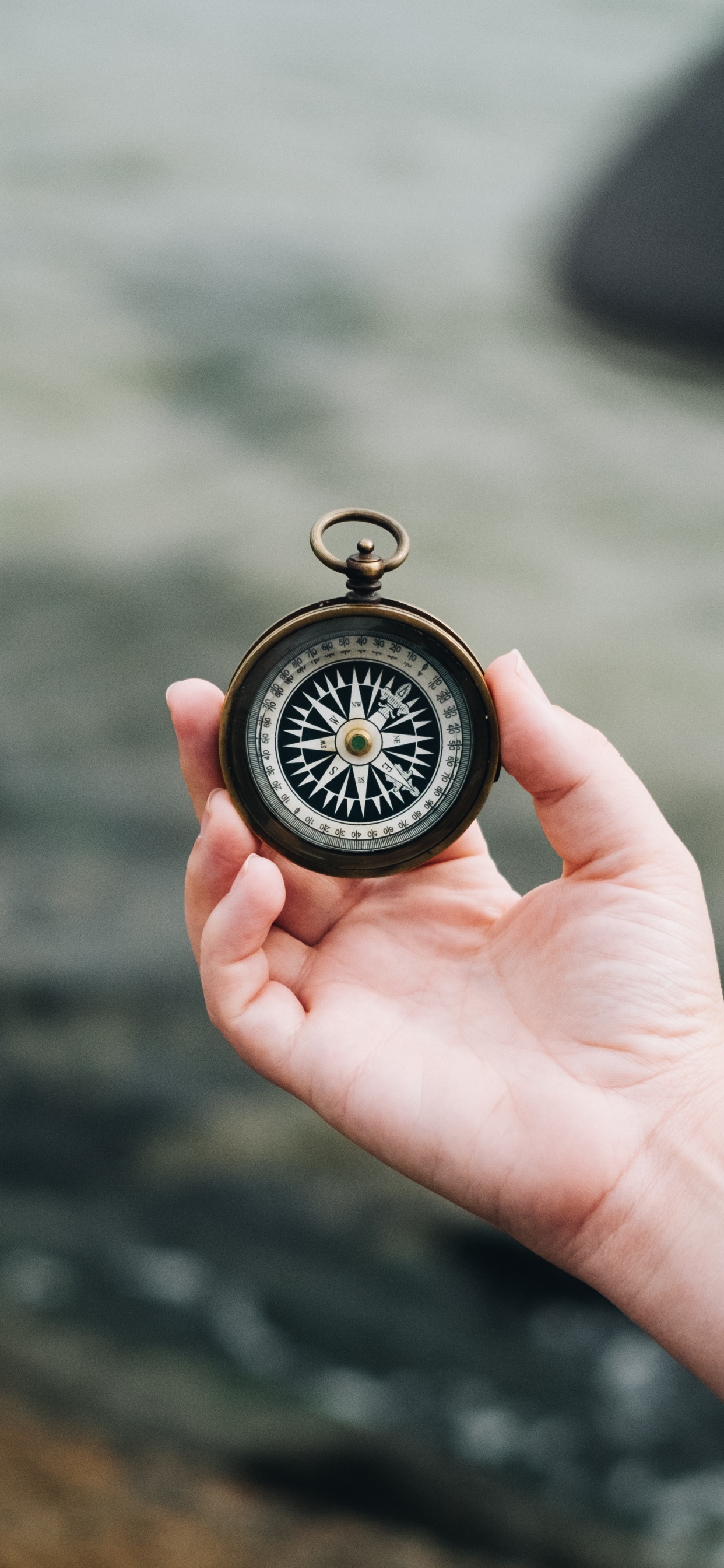 Person Holding Black and Silver Pocket Watch. Wallpaper in 1242x2688 Resolution