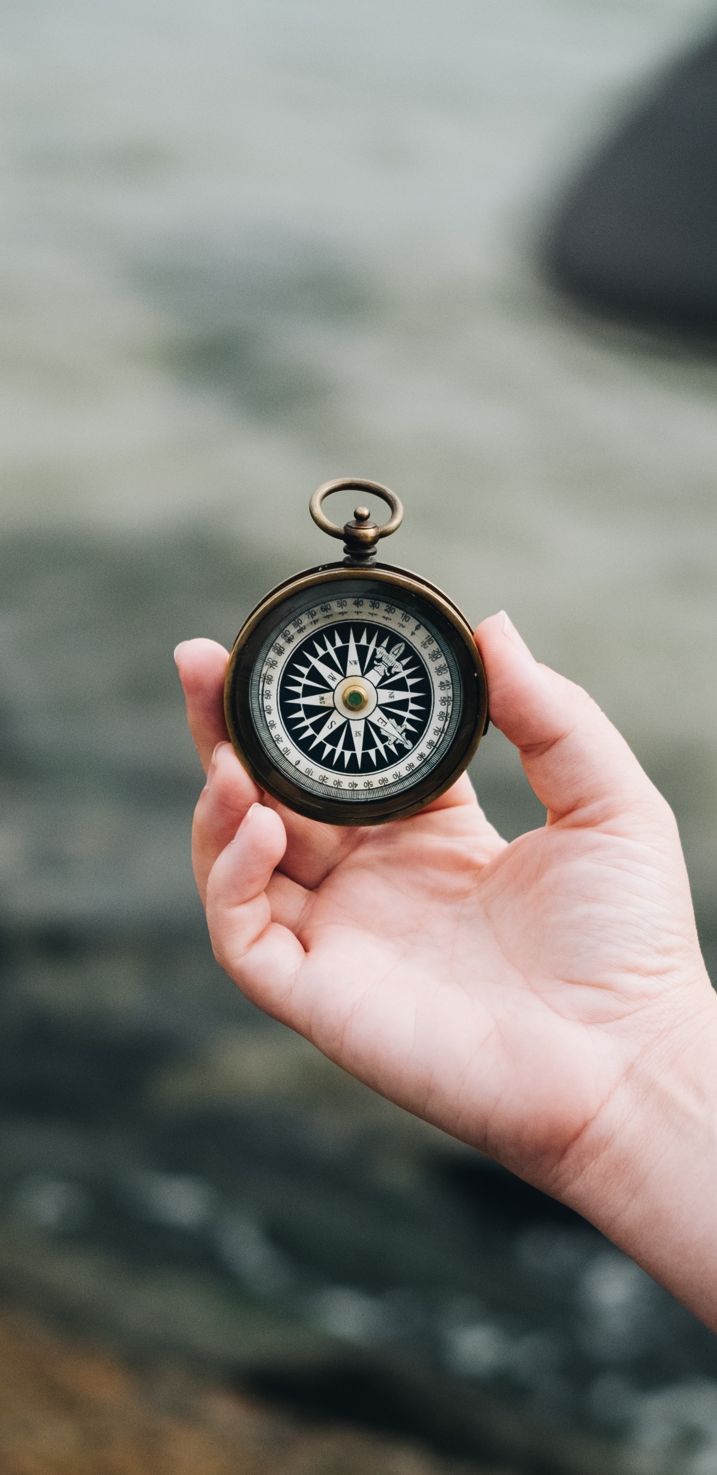 Person Holding Black and Silver Pocket Watch. Wallpaper in 1440x2960 Resolution