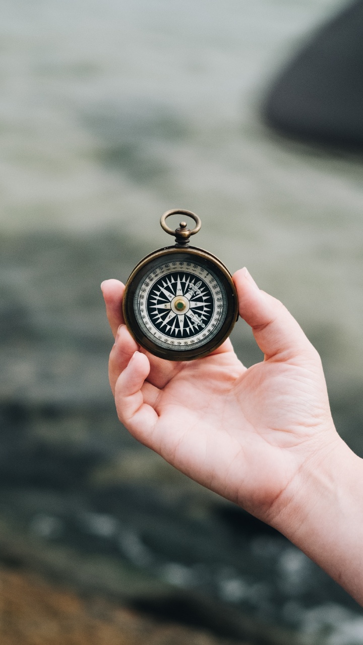 Person Holding Black and Silver Pocket Watch. Wallpaper in 720x1280 Resolution
