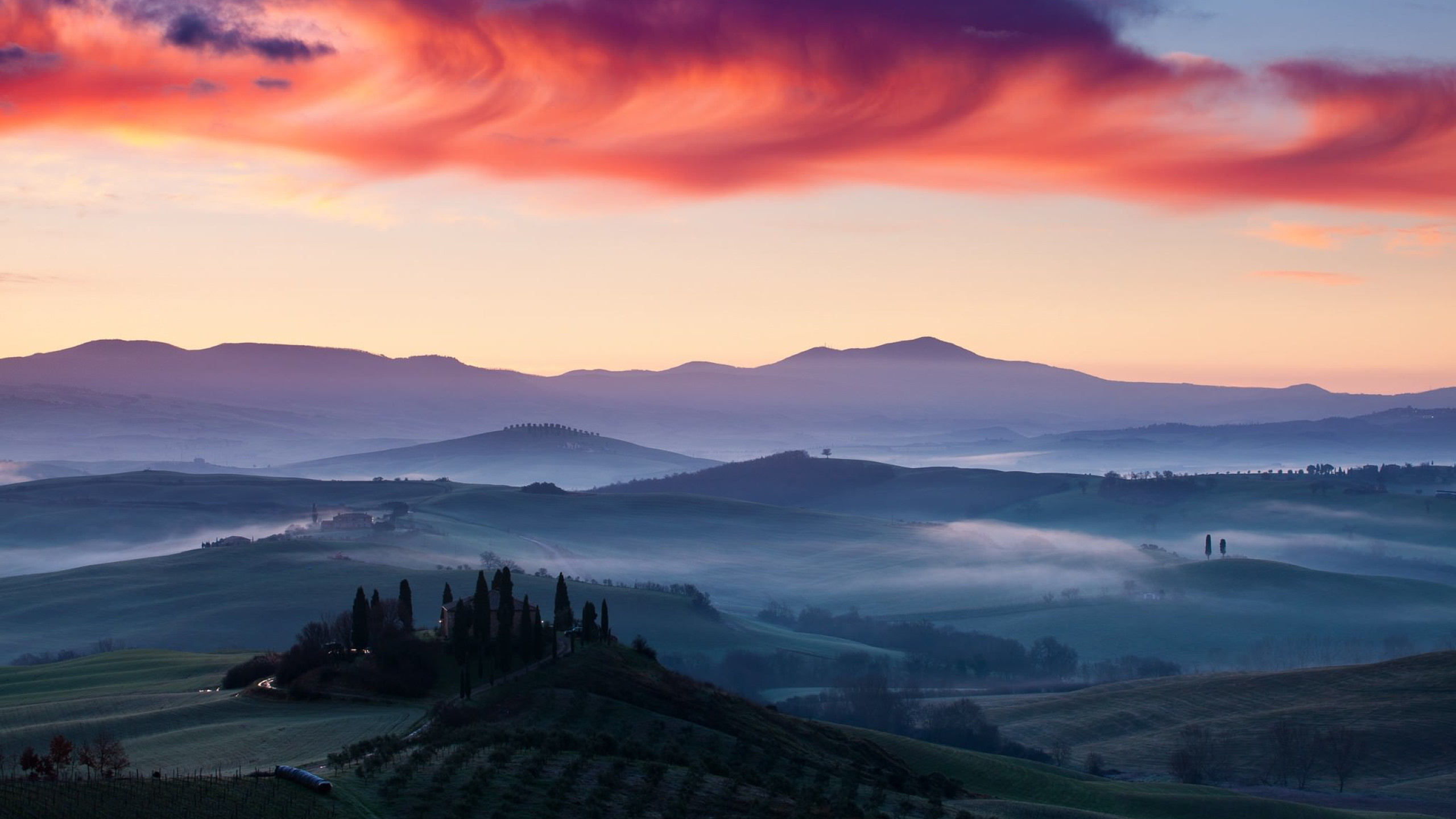 Green Mountains Under Orange Sky. Wallpaper in 2560x1440 Resolution