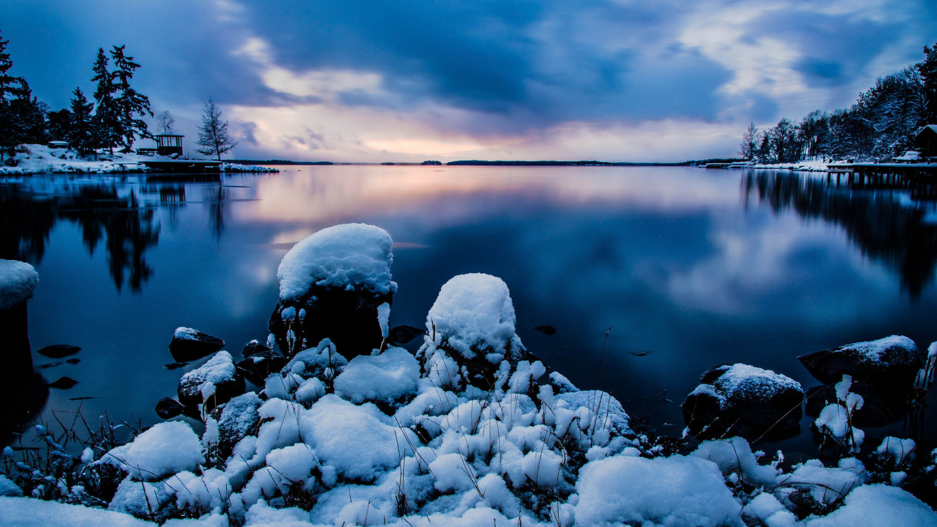 Gray and White Rocks on Body of Water Under Cloudy Sky. Wallpaper in 1366x768 Resolution
