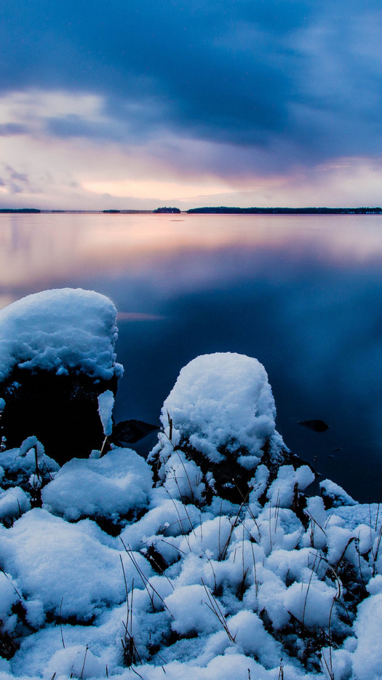 Gray and White Rocks on Body of Water Under Cloudy Sky. Wallpaper in 750x1334 Resolution