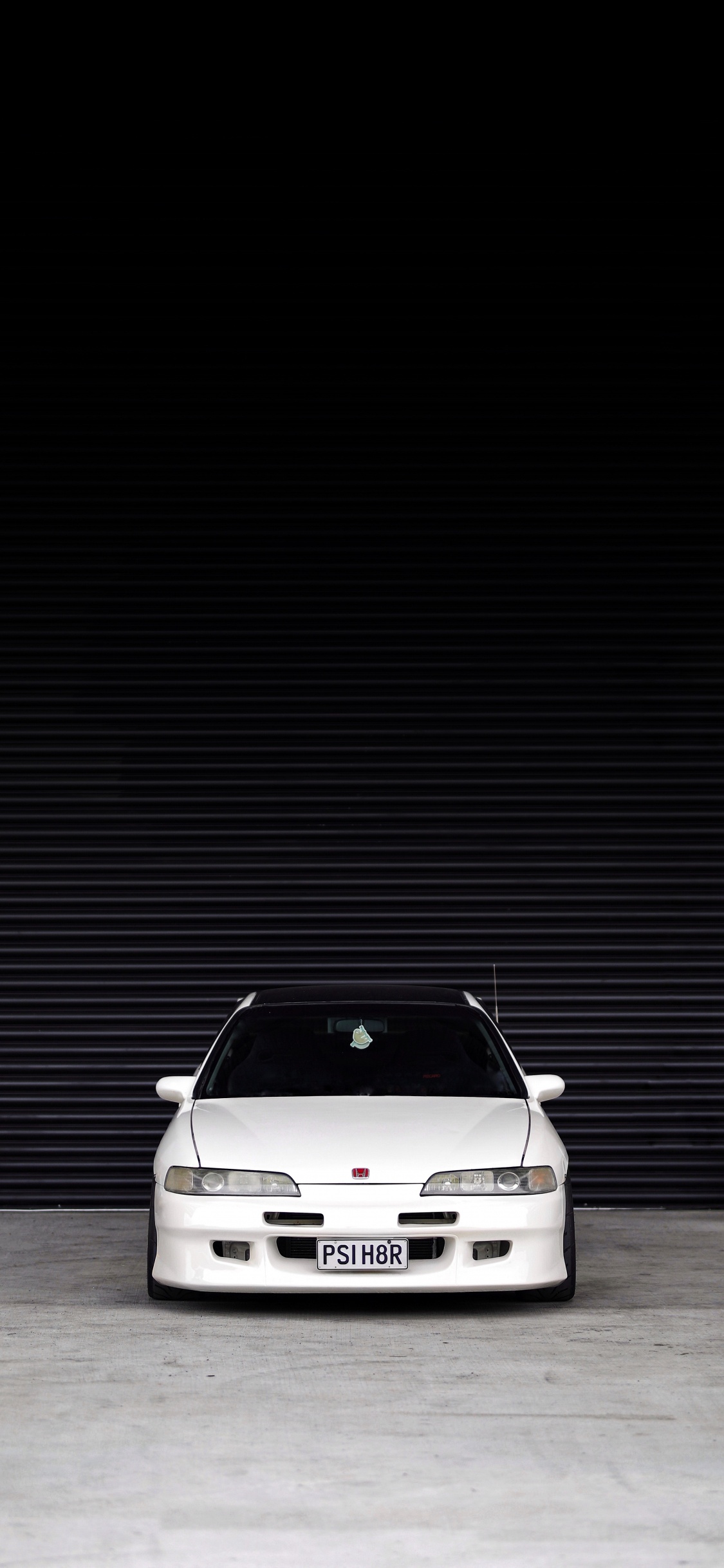 White Car in a White Room. Wallpaper in 1125x2436 Resolution