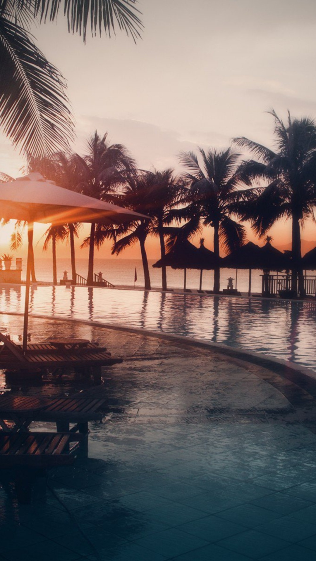 Brown Wooden Beach Lounge Chairs Near Beach During Sunset. Wallpaper in 1080x1920 Resolution