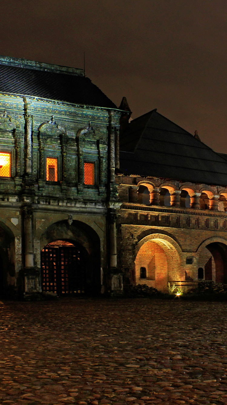 Braunes Und Grünes Betongebäude Während Der Nacht. Wallpaper in 750x1334 Resolution