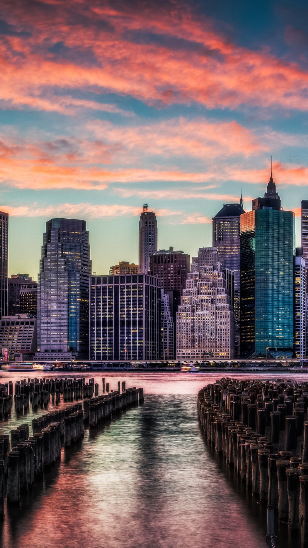 Bridge Over River Near City Skyline During Sunset. Wallpaper in 1080x1920 Resolution